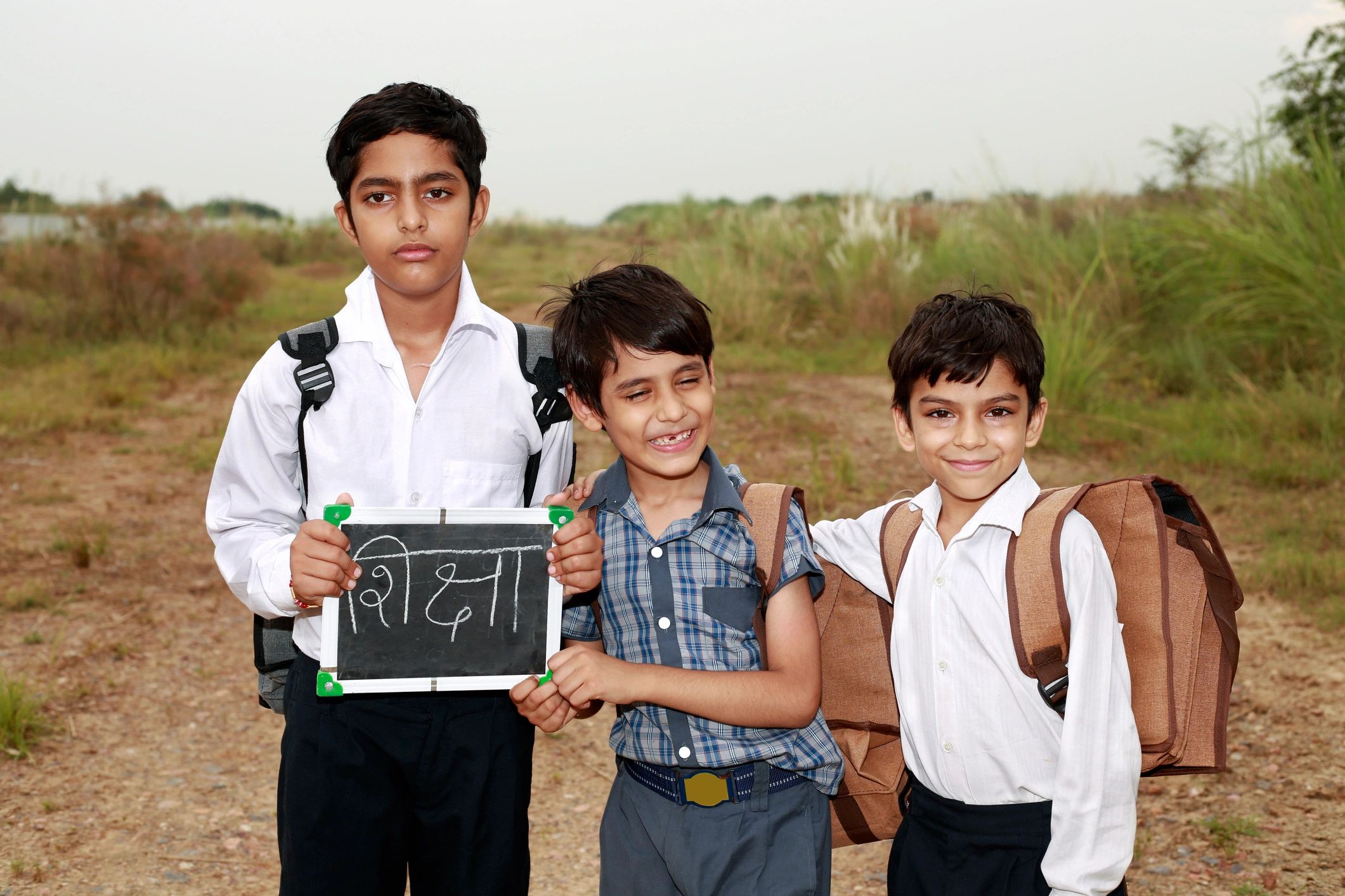 Schoolchildren holding writing slates after class