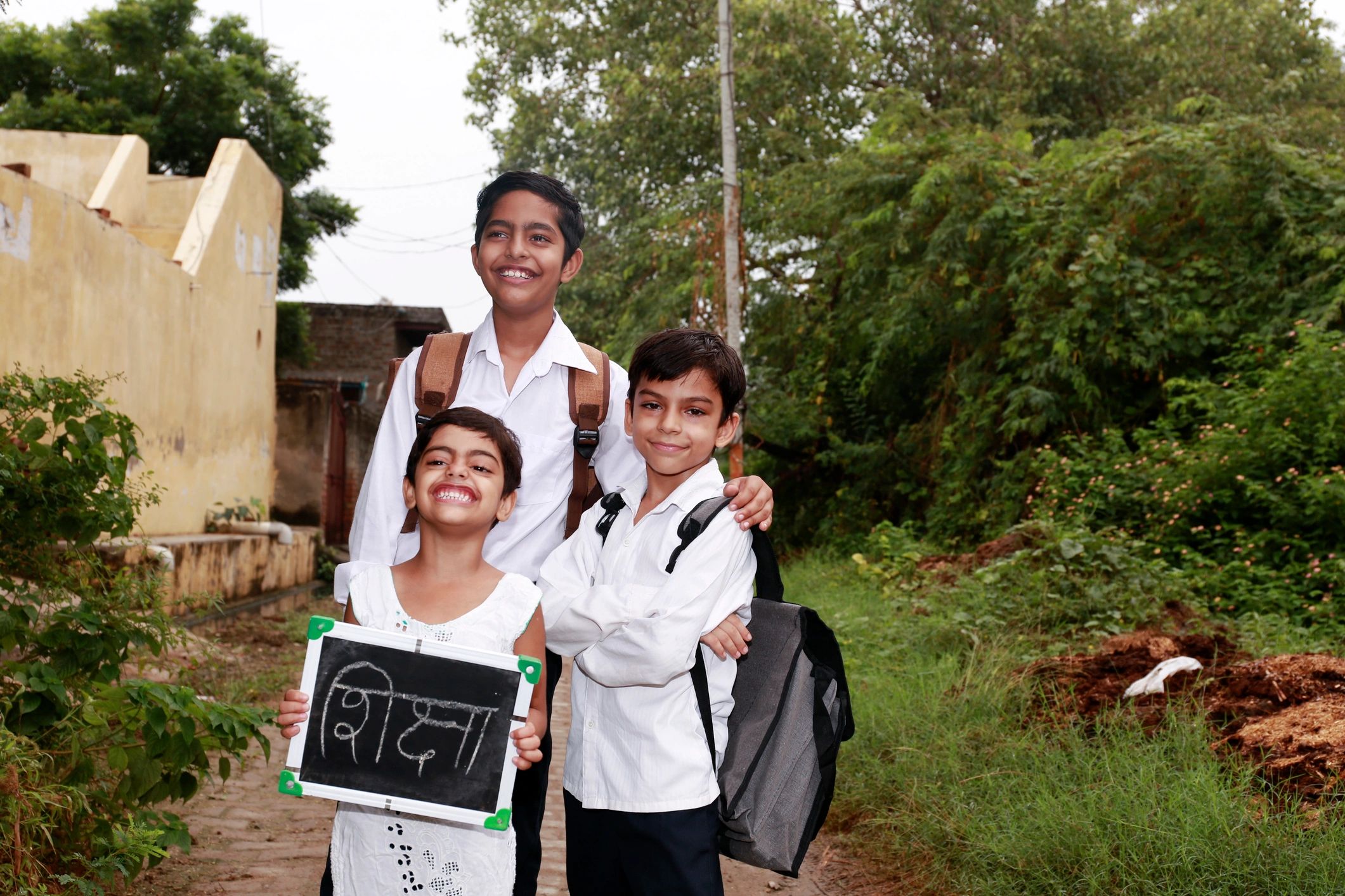 Schoolchildren holding writing slates, education support