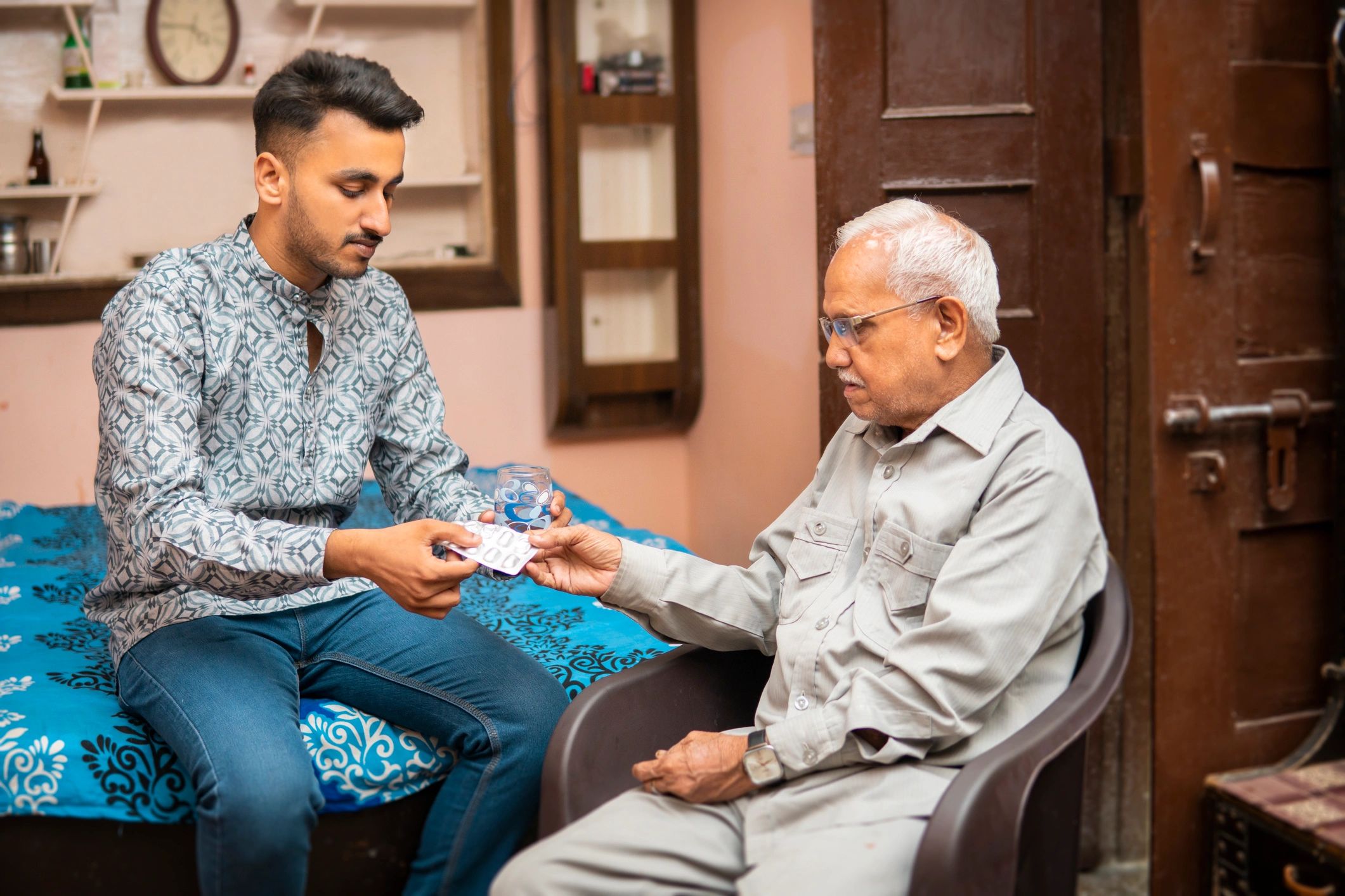 Young caregiver supporting an elderly family member at home
