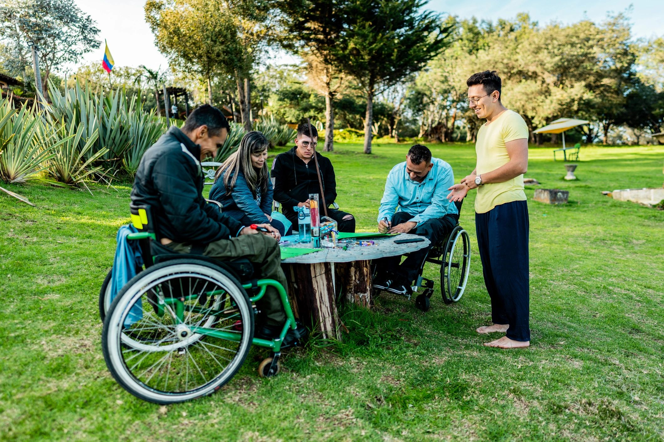People painting during a support group session, representing disability support